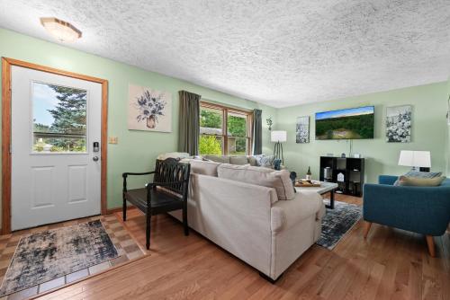 a living room with a couch and a chair at LAKEFRONT PARADISE 4 bedroom Home w direct lake access, Pets OK in Traverse City