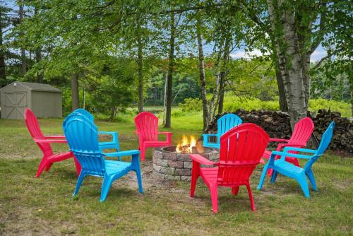 a group of colorful chairs around a fire pit at LAKEFRONT PARADISE 4 bedroom Home w direct lake access, Pets OK in Traverse City