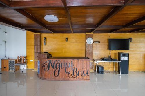 a room with a wooden wall with a clock on it at RedDoorz Syariah At Wisma Djokorio Poncokusumo in Gubukklakah