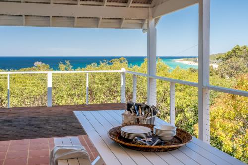 a table on a porch with a view of the ocean at Sea Spell I Private Properties in Dunsborough