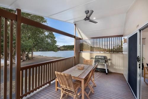 a deck with a table and chairs and a grill at Reflections Massy Greene - Holiday Park in Brunswick Heads