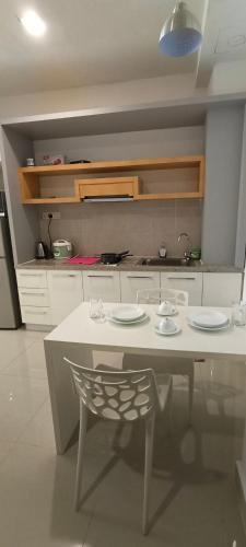 a kitchen with a table and a chair in it at Peace home09 in Cyberjaya