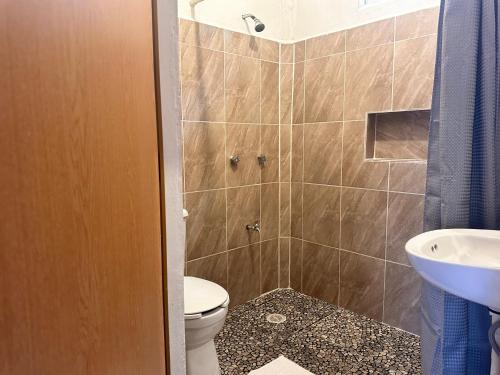 a bathroom with a toilet and a sink at Hotel Bacalar Sunshine in Bacalar