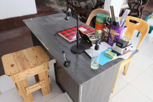 a wooden desk with a lamp and a chair at SPOT ON 92843 Paris Syariah in Nagoya