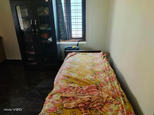 a bed sitting in a corner of a room at Entire 4 Bedroom villa in Trivandrum