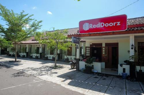 a red bookz building with a red sign on it at RedDoorz Syariah near Alun Alun Wonosari in Yogyakarta