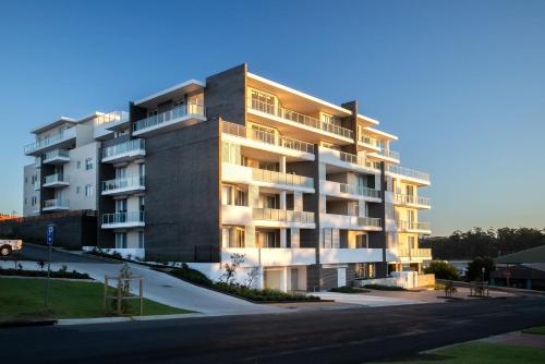 a large apartment building on the side of a street at Harbour Sunrise in Ulladulla