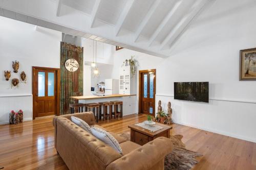 a living room with a couch and a table at Twin Peaks in Kangaroo Valley