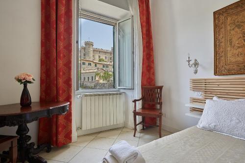 a bedroom with a window with a view of a building at LE CAMERE di VITTORIA in Bracciano