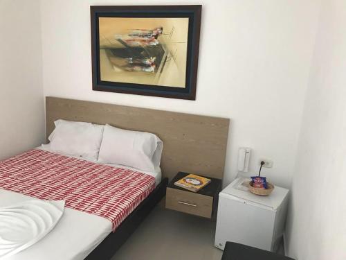 Rúm í herbergi á Hotel Madrid Deluxe Neiva