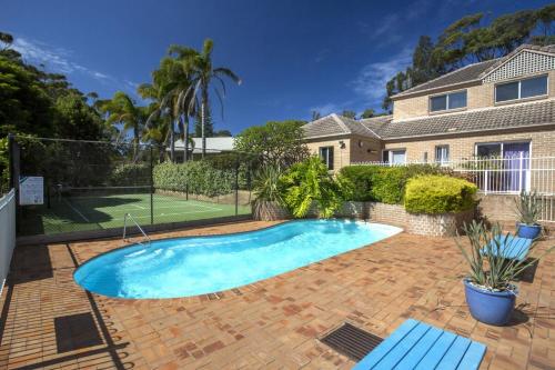 a swimming pool in the backyard of a house at No 1 Mollymook Beach in Mollymook