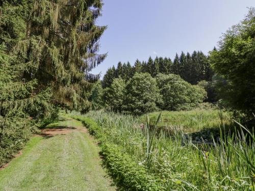 a path through a field with trees and grass at Kite's Nest in Eaton
