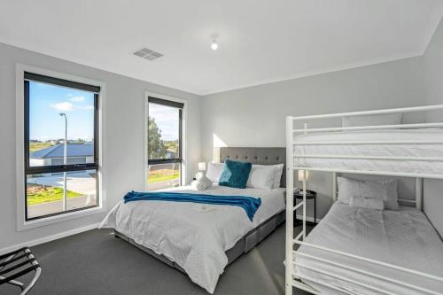 a bedroom with two bunk beds and a window at TheRiverbend43 Wellington Marina in Wellington East