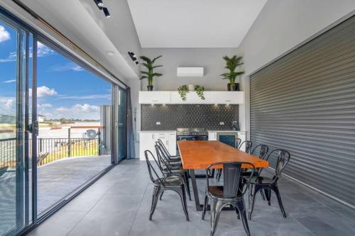 een eetkamer met een tafel en stoelen op een balkon bij TheRiverbend43 Wellington Marina in Wellington East