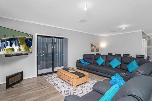 a living room with a couch and a tv at TheRiverbend43 Wellington Marina in Wellington East