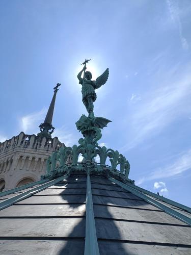 a statue of an angel on top of a building at Flambantvieux in Saint-Jean-de-Touslas