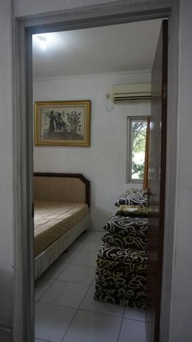 a bedroom with two beds and a mirror at Pondok zidane in Kukupu