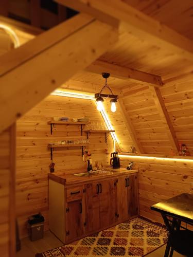 a kitchen in a log cabin with a sink at Mira bungalov rize in Ardeşen