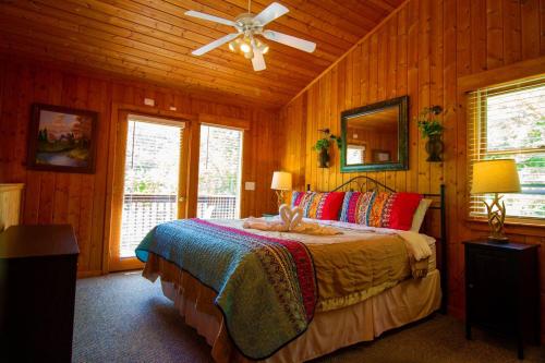 a bedroom with a bed and a ceiling fan at Smoky Waters Chalet in Sevierville
