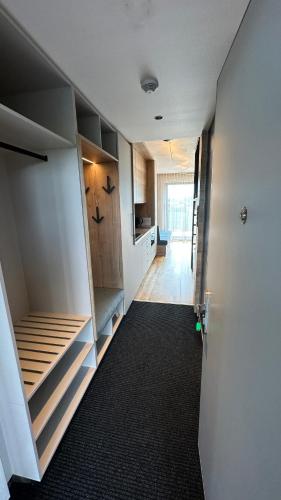 a room with a hallway with stairs and a kitchen at LAKE SIDE apartmán SEASCAPE - Černá v Pošumaví in Černá v Pošumaví