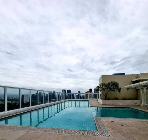 a large swimming pool on top of a building at Lovely 1 bedroom at Vista Shaw Residences in Manila