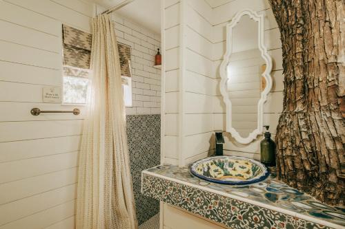 a bathroom with a sink and a mirror at Ashley's Treehouse at El Mistico in Nogal