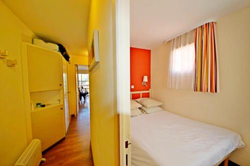 une petite pièce avec un lit et une fenêtre dans l'établissement CAP SOLEIL J2 appt 204, à Saint-Raphaël