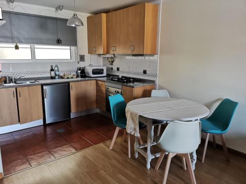 a kitchen with a table and chairs in a room at Flamingo's House - Beautiful View Over the Canal in Aveiro