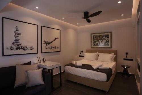 a bedroom with a bed and a ceiling fan at Only2Suites in Athens