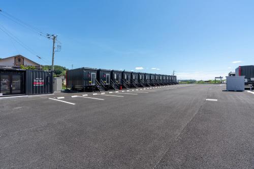 an empty parking lot with a long line of train cars at HOTEL R9 The Yard Tomioka in Tomioka