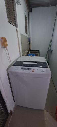a washing machine is sitting in a room at ABM Court Apartments in Nadi