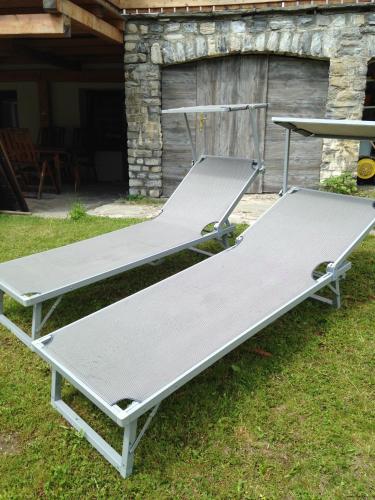 two beds sitting on the grass in a yard at Haus Willibald in Saalbach Hinterglemm