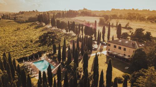 an aerial view of a house in a field of cypress trees at Agriturismo Terra Di Dio Toscanizzazione in Capannoli