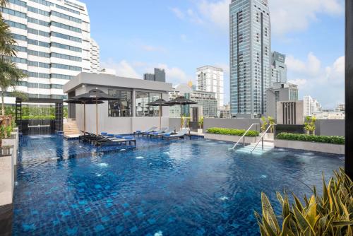 a large swimming pool on top of a building at Eleven Hotel Bangkok Sukhumvit 11 in Bangkok