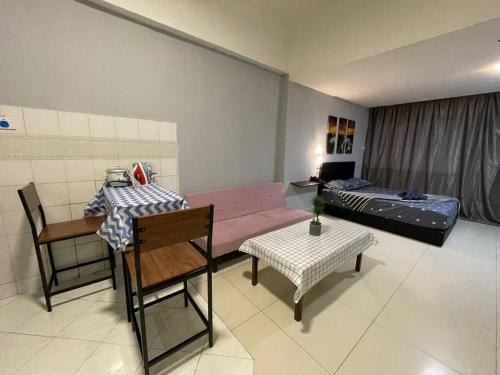 a living room with a couch and a bed at KK City A2Z Api Api Studio Homestay in Kota Kinabalu