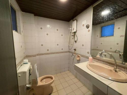 a bathroom with a toilet and a sink at KK City A2Z Api Api Studio Homestay in Kota Kinabalu
