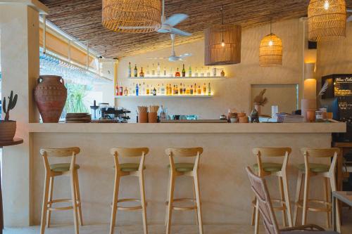a bar with wooden stools in a restaurant at Rustic and Blue Getaway in Patong Beach