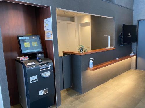 a bathroom with a cash register and a mirror at COB HOTEL Asakusa in Tokyo
