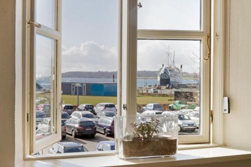 a window with a view of a parking lot at Hotel Færgegaarden in Fåborg