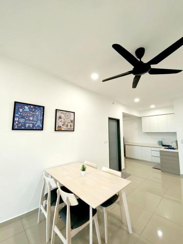 a dining room with a table and a ceiling fan at JOVIAL Modern Cozy Suite `Metropol BM BandarPerda in Bukit Mertajam