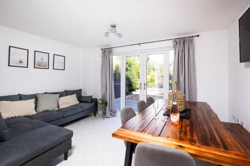 a living room with a wooden table and a couch at Coastal Retreat in Carmarthenshire in Llanelli