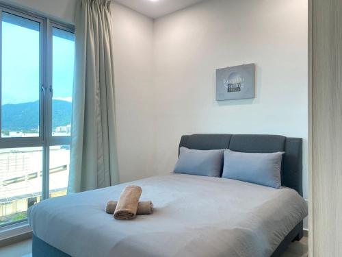 a bedroom with a bed with a large window at JOVIAL Modern Cozy Suite `Metropol BM BandarPerda in Bukit Mertajam