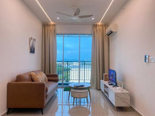 a living room with a couch and a table at JOVIAL Modern Cozy Suite `Metropol BM BandarPerda in Bukit Mertajam
