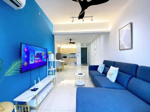a living room with a blue couch and a blue wall at JOVIAL Modern Cozy Suite `Metropol BM BandarPerda in Bukit Mertajam
