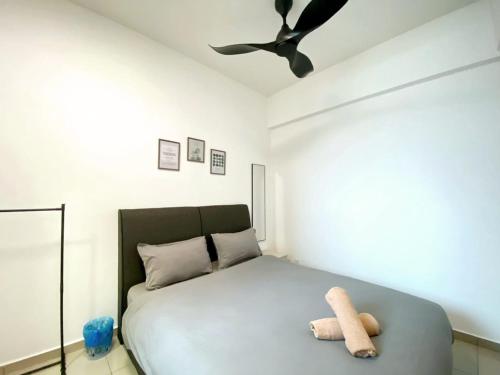 a bedroom with a bed with a teddy bear on it at JOVIAL Modern Cozy Suite `Metropol BM BandarPerda in Bukit Mertajam