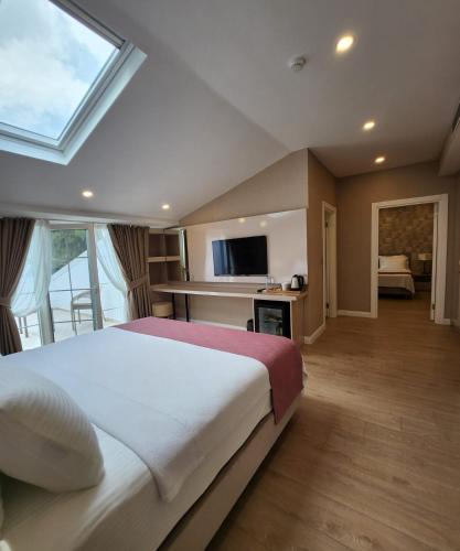 a bedroom with a large bed and a large window at Villa No 44 in Darıca