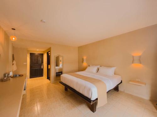 a bedroom with a large white bed in a room at Casa Solana in Patong Beach