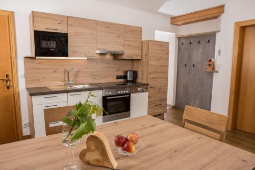 a kitchen with a table with fruit on it at Lochgrubgut in Altenmarkt im Pongau