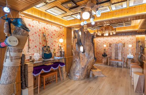 a room with a large tree in the middle of it at Longji One Art Hotel in Longsheng