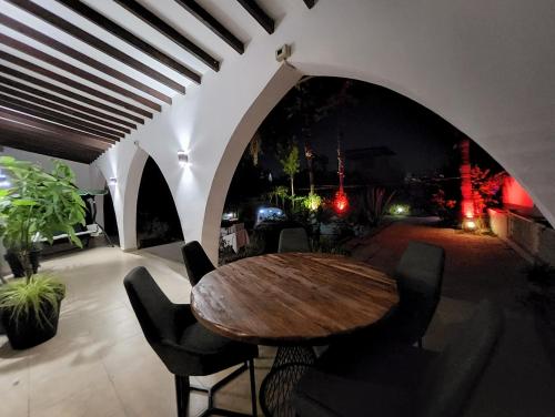 a dining room with a wooden table and chairs at Luxuriant Houses Kyrenia in Kérynia